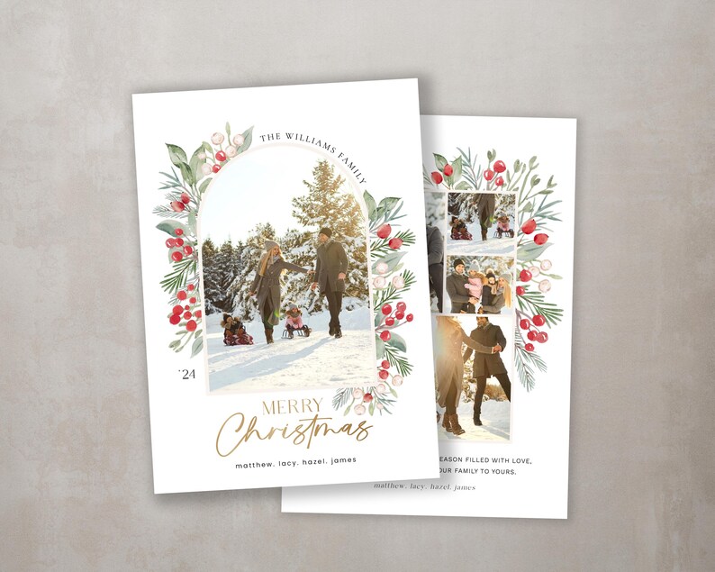 May include: A Christmas card featuring a family of four in a snowy winter scene. The card has a watercolor border of red berries and green leaves. The text "THE WILLIAMS FAMILY" is at the top of the card, and the text "MERRY CHRISTMAS" is at the bottom. The names "matthew, lacy, hazel, james" are listed below the greeting.
