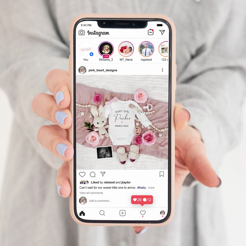 May include: A white onesie with the text "BABY GIRL Parker MARCH 2024" on it. The onesie is surrounded by pink and white flowers, a wooden bunny, and a wooden bead garland. The onesie is on a pink blanket.