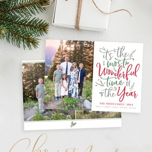 May include: A Christmas photo card template with a family photo and the text "it's the most Wonderful time of the Year". The template is decorated with holly and greenery.