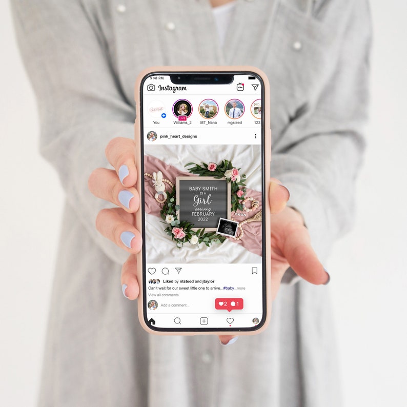 May include: A pink and white floral wreath surrounds a chalkboard sign that reads "Baby Smith is a Girl arriving February 2022". The sign is surrounded by a pink ribbon, a white bunny, a baby rattle, and a small ultrasound image.