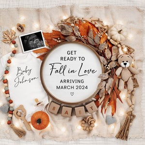 May include: A baby announcement with an autumn theme. A white babygrow with the text "Baby Johnson" is surrounded by autumn leaves, a wooden sign that says "Get Ready to Fall in Love Arriving March 2024", and wooden blocks that spell out "BABY".