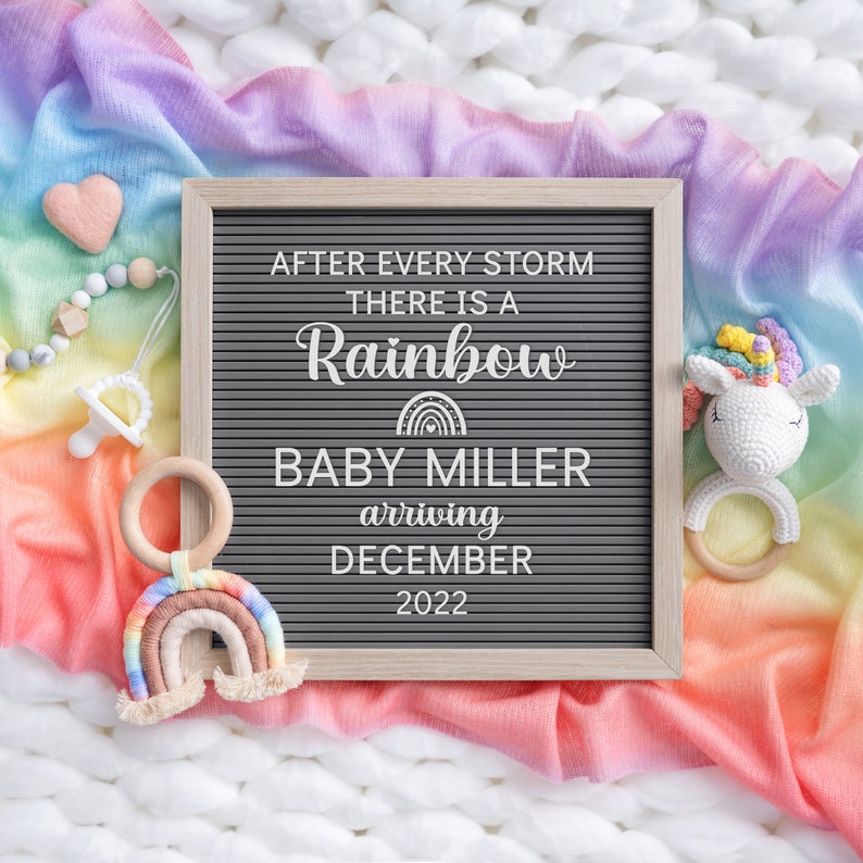 May include: A letter board with the text "After every storm there is a rainbow Baby Miller arriving December 2022". The board is surrounded by a rainbow coloured blanket, a wooden rainbow toy, a unicorn toy, and a wooden teething ring.