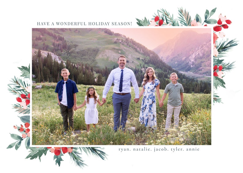 May include: A family of five poses for a holiday photo in front of a mountain range. The family is standing in a field of wildflowers. The text "HAVE A WONDERFUL HOLIDAY SEASON!" appears at the top of the image. The text "ryan, natalie, jacob, tyler, annie" appears at the bottom of the image.