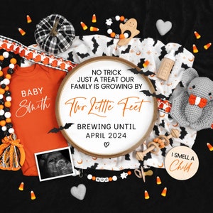 May include: A Halloween-themed baby announcement with a white embroidery hoop that reads "No trick just a treat our family is growing by two little feet brewing until April 2024."  The hoop is surrounded by a variety of Halloween decorations, including a baby onesie, a pacifier, a rattle, a stuffed bat, and candy corn.