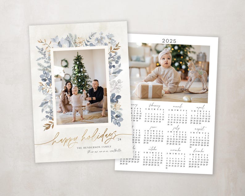 May include: A Christmas card with a watercolor floral border in shades of blue and gold. The card features a photo of a family of three standing in front of a Christmas tree. The text "Happy Holidays" is written in gold script. The card also includes a 2025 calendar.