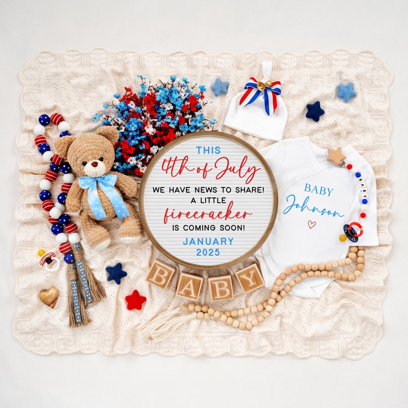 May include: A red, white, and blue themed baby announcement with a sign that reads "This 4th of July we have news to share! A little firecracker is coming soon! January 2025". There are also wooden blocks that spell out "BABY", a teddy bear, a baby onesie, and other patriotic decorations.