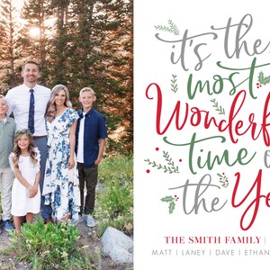 May include: A Christmas card featuring a family of five standing in front of a mountain range. The text on the card reads "It's the most Wonderful time of the Year." The family's last name is Smith.