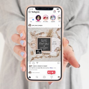 May include: A smartphone displays an Instagram post announcing a baby's arrival. The post includes a letter board with "We Can't Wait to Meet You! September 2023", a baby onesie, ultrasound photo, and baby-themed decorations.