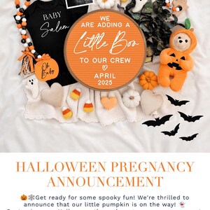 May include: Halloween pregnancy announcement with a pumpkin-themed sign that reads "We are adding a little boo to our crew April 2025". The sign is orange with white lettering and is surrounded by Halloween decorations, including a baby onesie, a pumpkin-shaped stuffed animal, and bats.