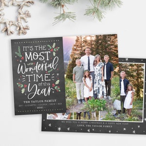 May include: A Christmas card with a chalkboard background featuring the text "It's the Most Wonderful Time of the Year." The card also includes a photo of a family standing in a forest setting. The text "The Taylor Family" and the year "2021" are also included on the card.
