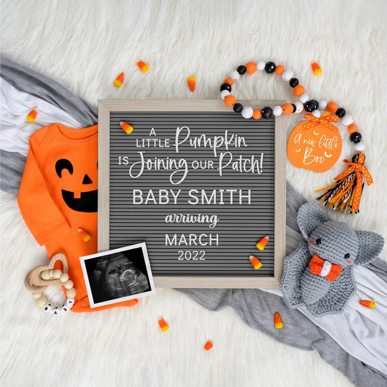 May include: A Halloween-themed baby announcement with a letter board that reads "A little Pumpkin is joining our Patch! Baby Smith arriving March 2022". There is an orange onesie with a jack-o-lantern face, a black and white ultrasound image, a wooden rattle, and a gray crocheted bat.