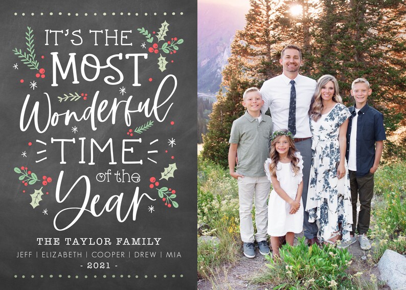 May include: A Christmas card with a chalkboard background featuring the text "It's the Most Wonderful Time of the Year." The card also includes a photo of a family of six standing in front of a mountain range. The family is dressed in casual clothing and smiling.