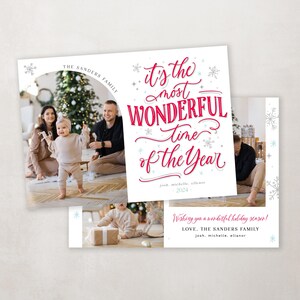 May include: A Christmas card featuring a family of three with a Christmas tree in the background. The text on the card reads "It's the most WONDERFUL time of the Year" and "Wishing you a wonderful holiday season! LOVE. THE SANDERS FAMILY josh. michelle. allanor 2024".