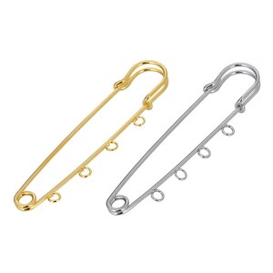 May include: Two safety pins with loops. One is gold and the other is silver.