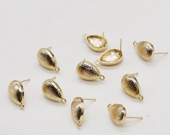 May include: A set of ten gold-toned earring settings with a teardrop shape. The settings have a post and a loop for attaching a charm or bead.