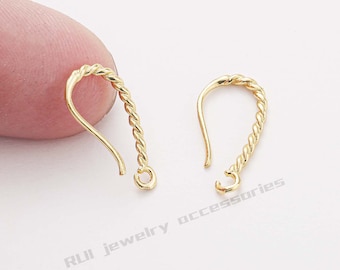 May include: Two gold-toned twisted wire earring hooks. The hooks are about 1 inch long and have a small loop at the top.