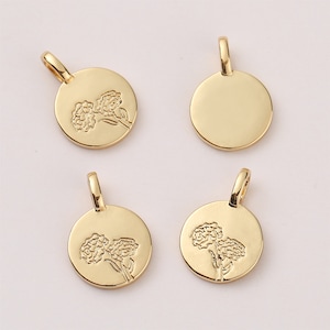 May include: Four gold-toned metal charms, two featuring a floral design and two plain. The charms are round and have a loop at the top for attaching to a necklace or bracelet.