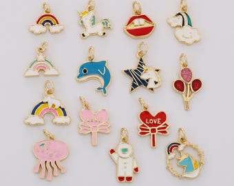May include: A collection of gold-toned charms with colorful enamel designs. The charms include rainbows, a unicorn, lips, a dolphin, a star, balloons, a jellyfish, hearts, an astronaut, and a unicorn in a wreath. These charms are suitable for jewelry making.