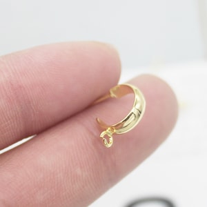 May include: Gold-toned metal pendant bail with a smooth, rounded shape and a small loop at the top.