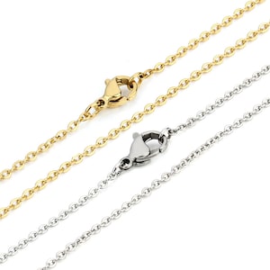 May include: Two chain necklaces, one gold and one silver, with lobster claw clasps. The chains are both delicate and have a simple, classic design.