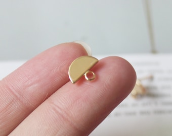 May include: Gold-toned metal half-circle charm with a loop for attaching to jewelry or other crafts.