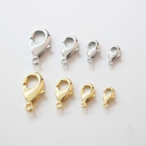 May include: Assortment of silver and gold lobster clasps in various sizes. These clasps are perfect for jewelry making, crafting, and DIY projects.