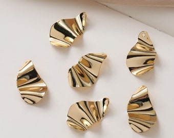 May include: Six gold-coloured metal earring charms shaped like ruffled leaves. The charms have a hole at the top for attaching to jewellery.