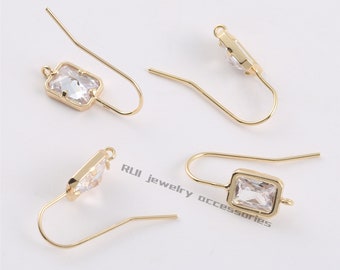 May include: Four gold-tone earring hooks with clear rectangular crystal stones. The hooks are designed for attaching to jewelry findings.