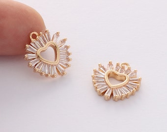 May include: Two gold-tone heart-shaped charms with a clear crystal halo. The charms have a loop at the top for attaching to jewelry.