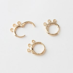 May include: Three gold-toned earring hoops with three jump rings on each hoop. The hoops are open and ready to be used for jewelry making.