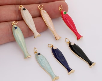 May include: A collection of colorful fish-shaped pendants. Each pendant features a gold-colored outline and a small loop at the top for hanging. The fish are painted in various colors, including red, blue, black, and pastel shades, with a small gem at the eye.