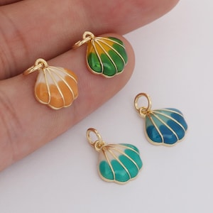 May include: Four small seashell charms with gold-colored metal edging and loops. The shells are painted with colorful enamel in shades of orange, green, blue, and white. The charms are designed for jewelry making.