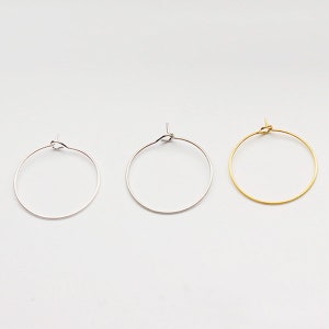 May include: Three hoop earrings in different finishes: silver, gold, and rose gold. The hoops are simple and elegant, perfect for everyday wear.