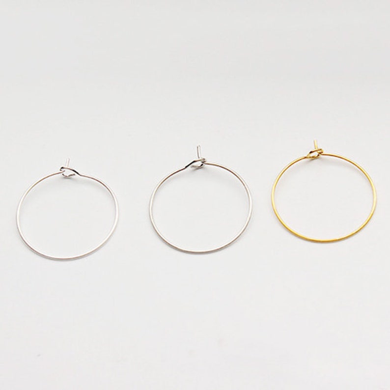 May include: Three hoop earrings in different finishes: silver, gold, and rose gold. The hoops are simple and elegant, perfect for everyday wear.
