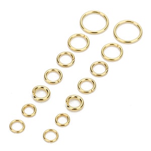 May include: A set of 12 gold jump rings in various sizes. The jump rings are arranged in two rows, with the largest rings at the top and the smallest rings at the bottom.