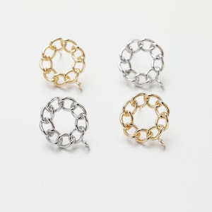 Puede incluir: Un conjunto de cuatro pendientes de cadena de eslabones dorados y plateados. Cada pendiente es un círculo de cadenas enlazadas con un pequeño cierre de gancho.