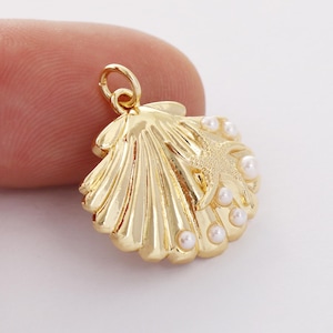 May include: Gold-tone seashell charm with a starfish and white pearl accents.