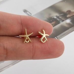 May include: Two gold-colored starfish charms with a jump ring for attaching to jewelry or other crafts.