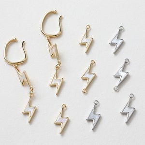 May include: A set of 10 gold and silver lightning bolt charms with white accents. The charms are perfect for jewelry making or adding a touch of sparkle to any project.