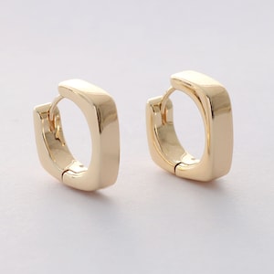 May include: A pair of gold hoop earrings with a square shape. The earrings are made of a shiny metal and have a simple design.