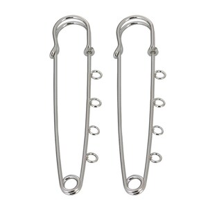 May include: Two silver safety pins with four jump rings attached to each pin.