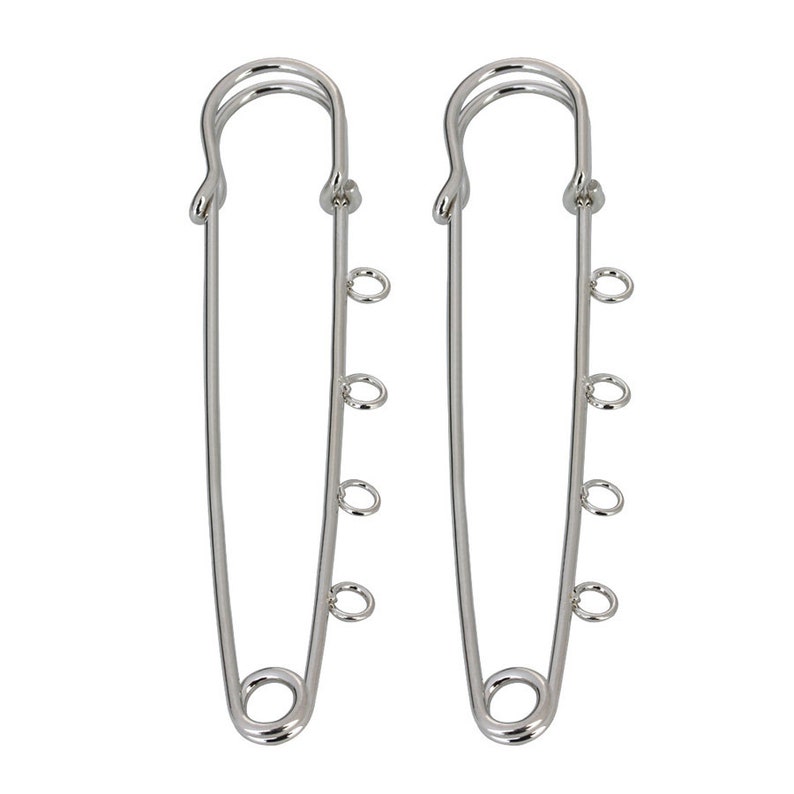 May include: Two silver safety pins with four jump rings attached to each pin.