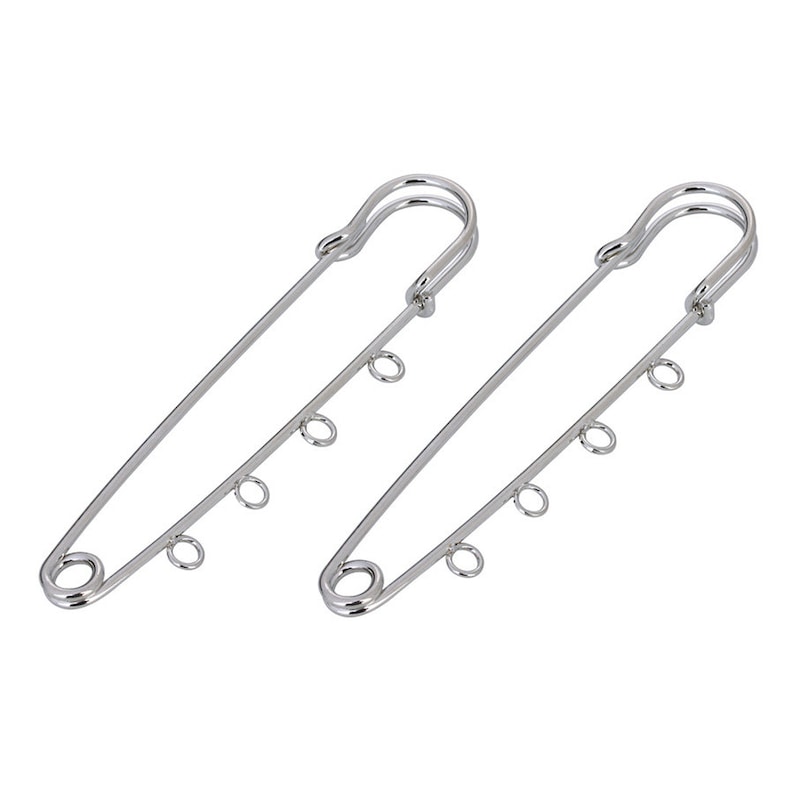 May include: Two silver safety pins with multiple loops on each pin.