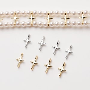 May include: A set of silver and gold star-shaped connector charms. The charms have a loop on each end for attaching to jewellery.