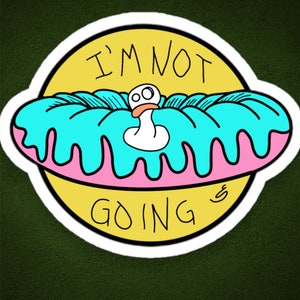 May include: A white sticker with a yellow background and the text "I'm not going" in black. A pink and blue donut with a white cartoon duck inside is on top of the yellow background.