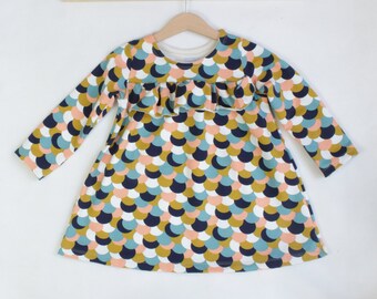 French Terry long-sleeved dress with ruffle detail, circle pattern in salmon pink, ice blue, navy and ochre, A-line cut