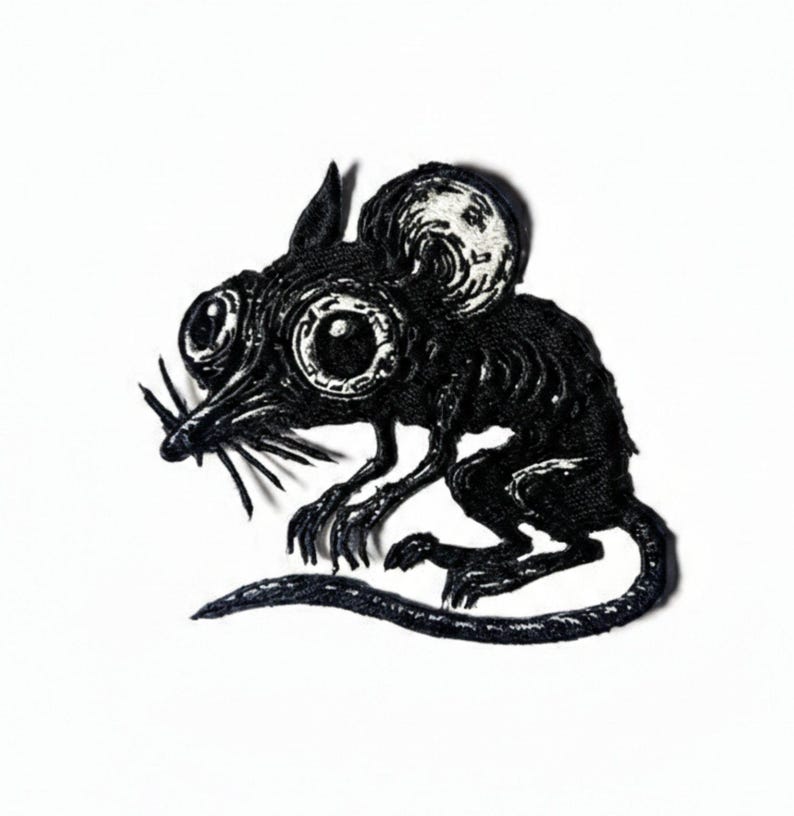 Detailed black and white embroidered patch of a stylized gothic mouse with large eyes and anatomical skeletal ribs, vintage woodcut engraving style.