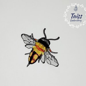 May include: Embroidered patch of a bumblebee with black, yellow, and orange details. The bumblebee is flying with its wings spread out. The patch is on a white background.
