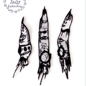 May include: Three black and white embroidered patches of skeletal fingers with long, sharp nails. The fingers are detailed with bone and tendons.