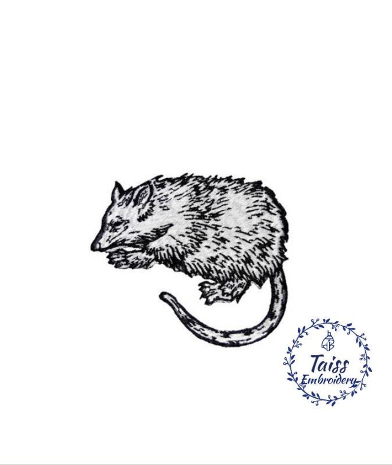 May include: Black and white embroidered patch of a possum curled up sleeping. The patch is ideal for adding a touch of whimsy to your projects.